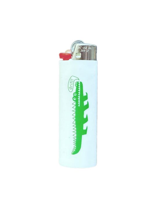 Lighter with a green alligator design on a white background